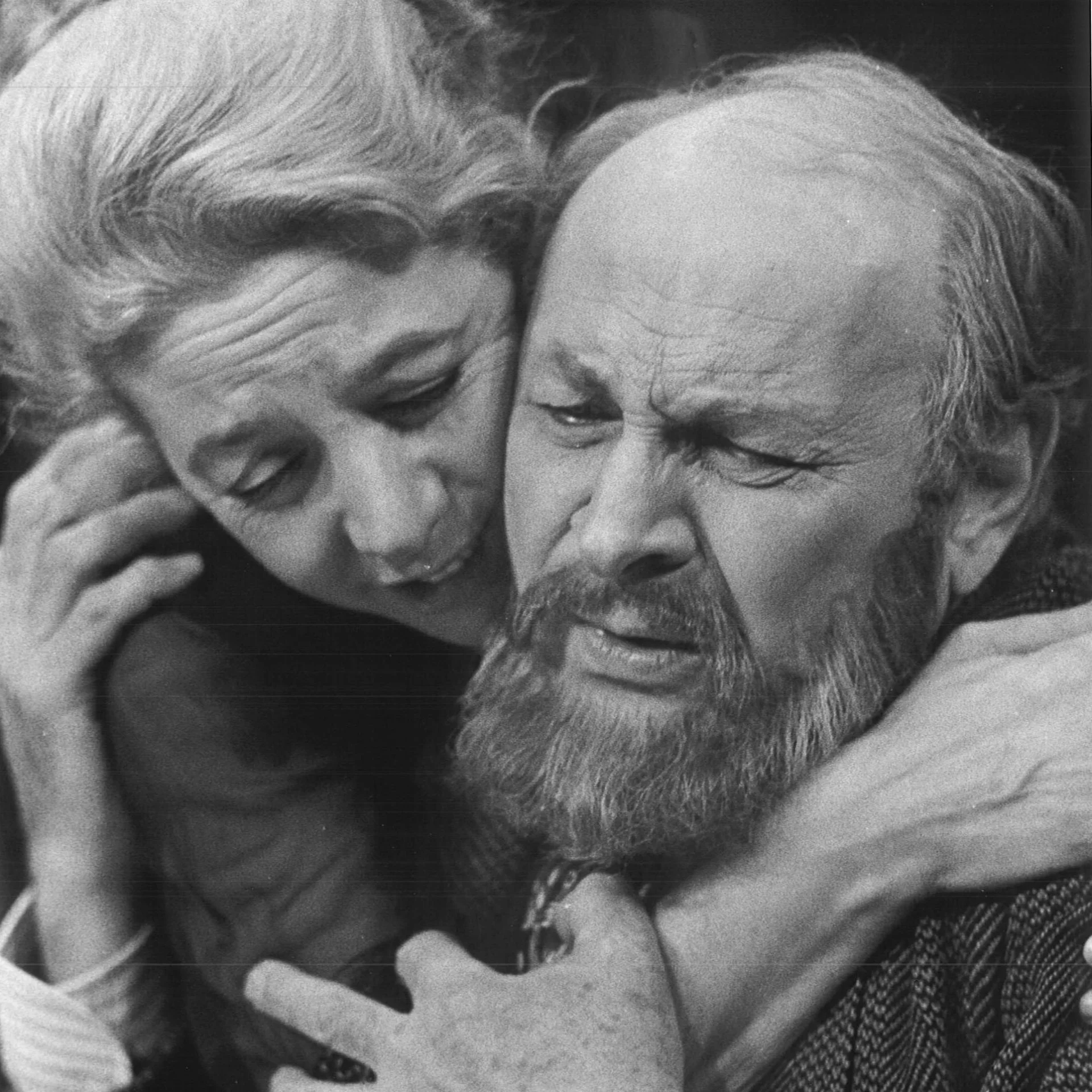 A men and woman are seen holding each other and both are crying