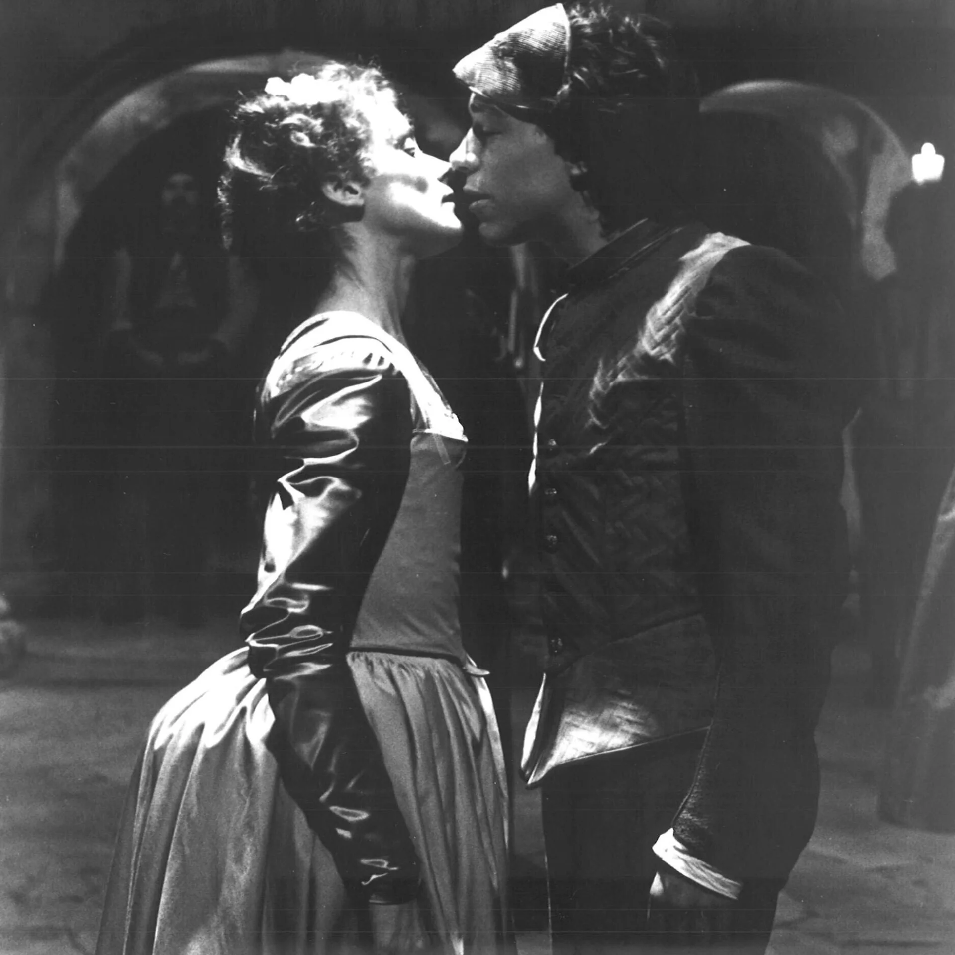 A man and a woman are seen kissing.