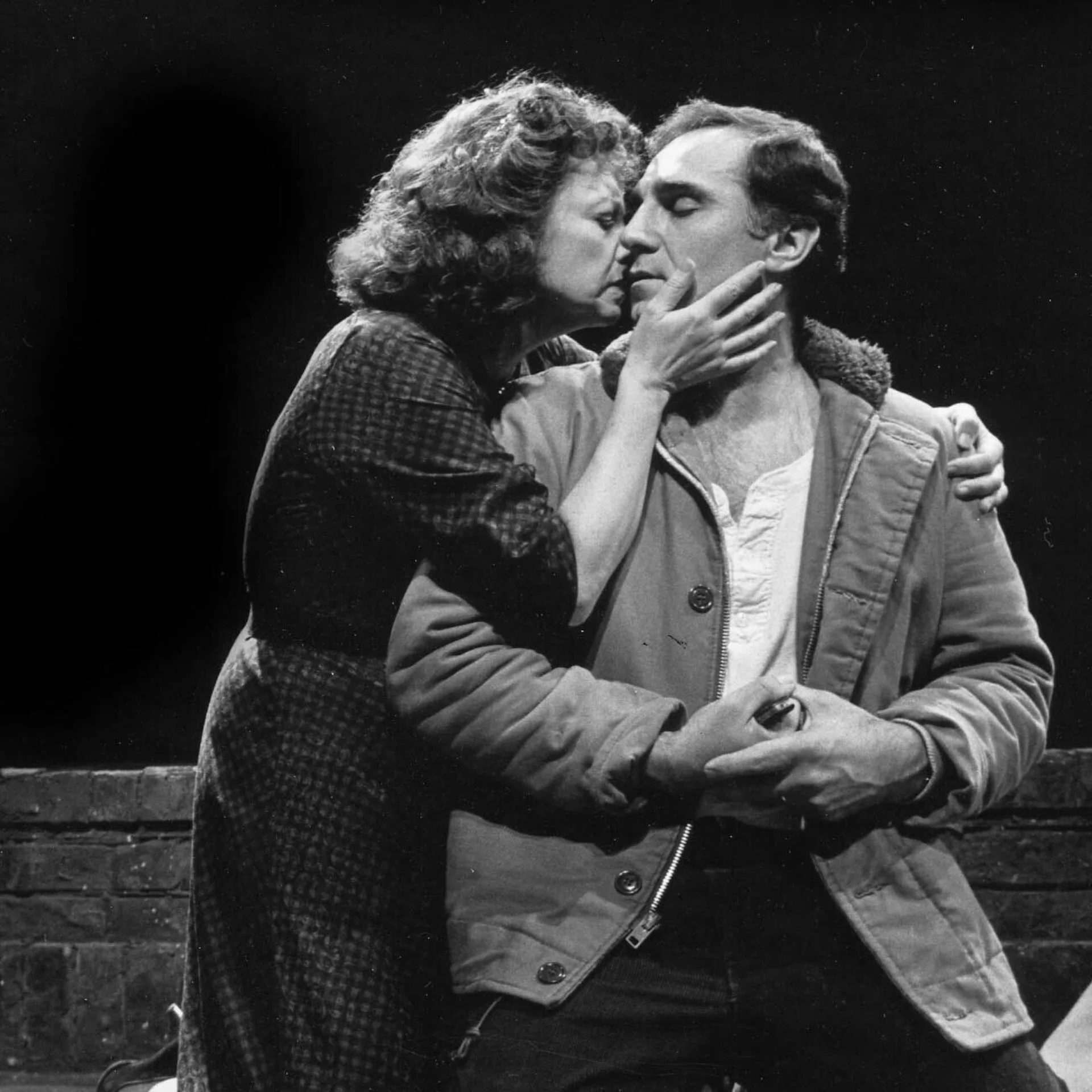 A woman and a man look as if they are about to kiss.