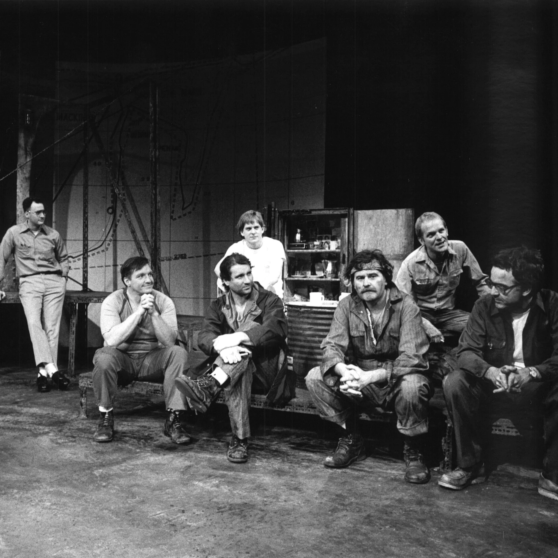 A group of men are sitting together talking.