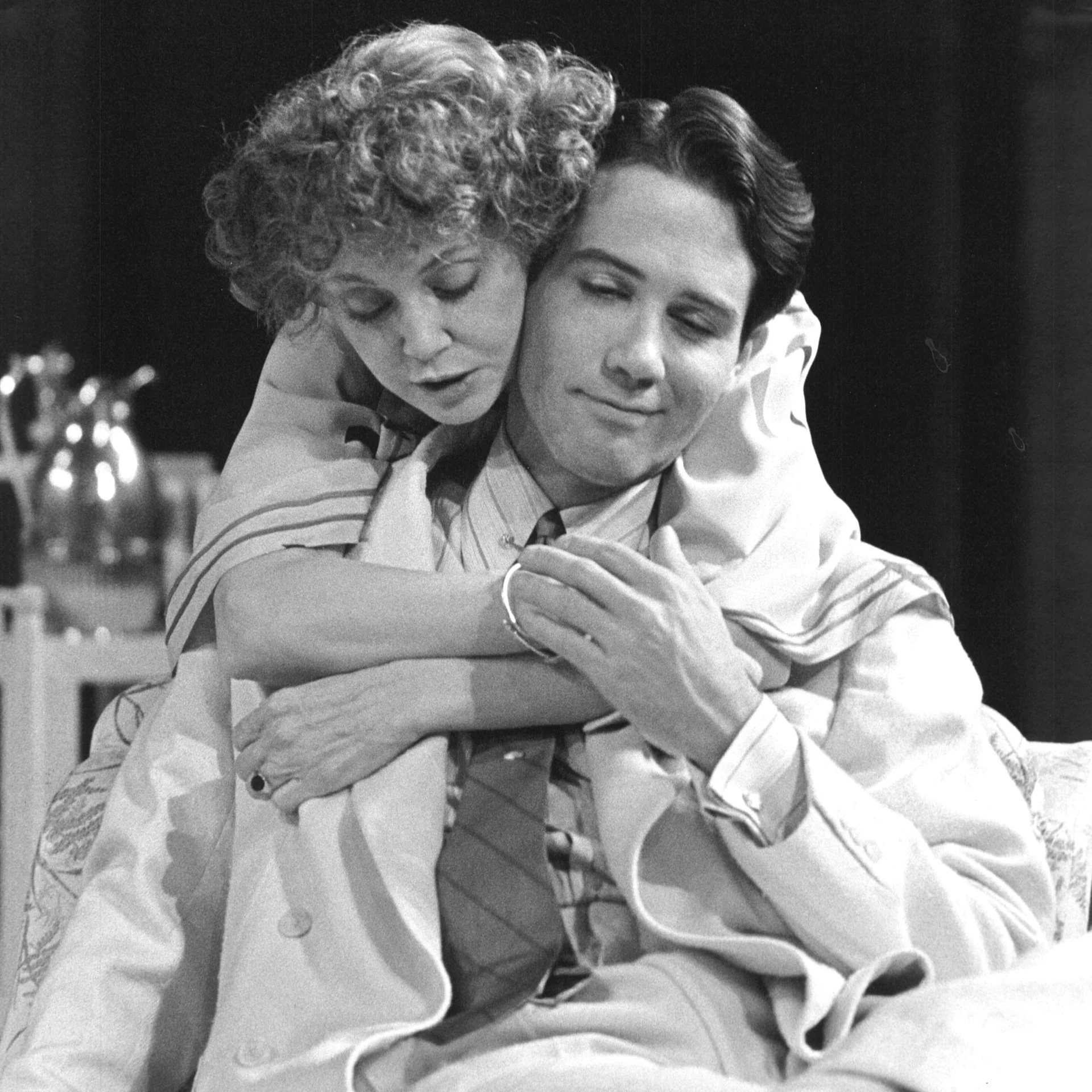 A woman is hugging a man from behind.