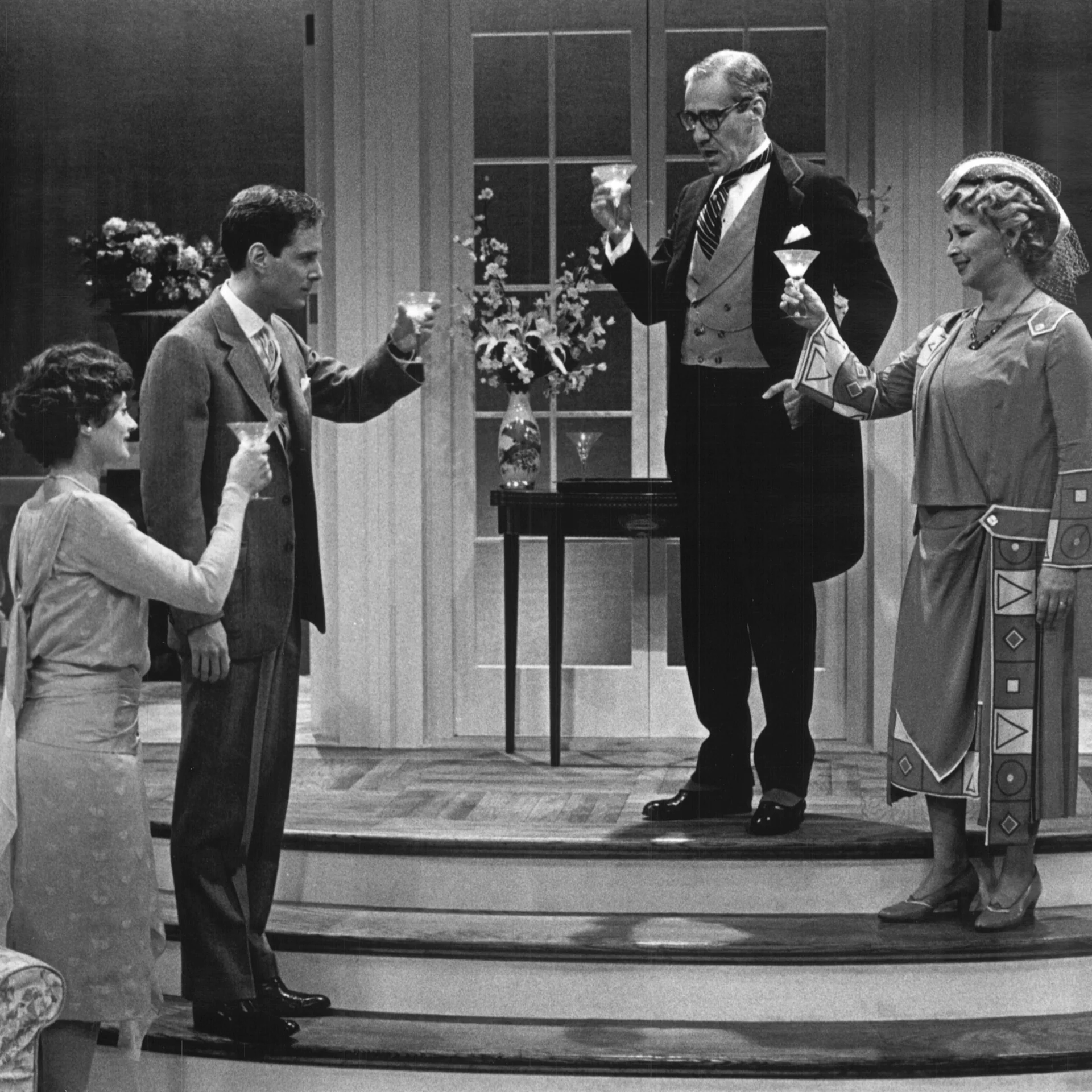 A group of people are standing together toasting their glasses.