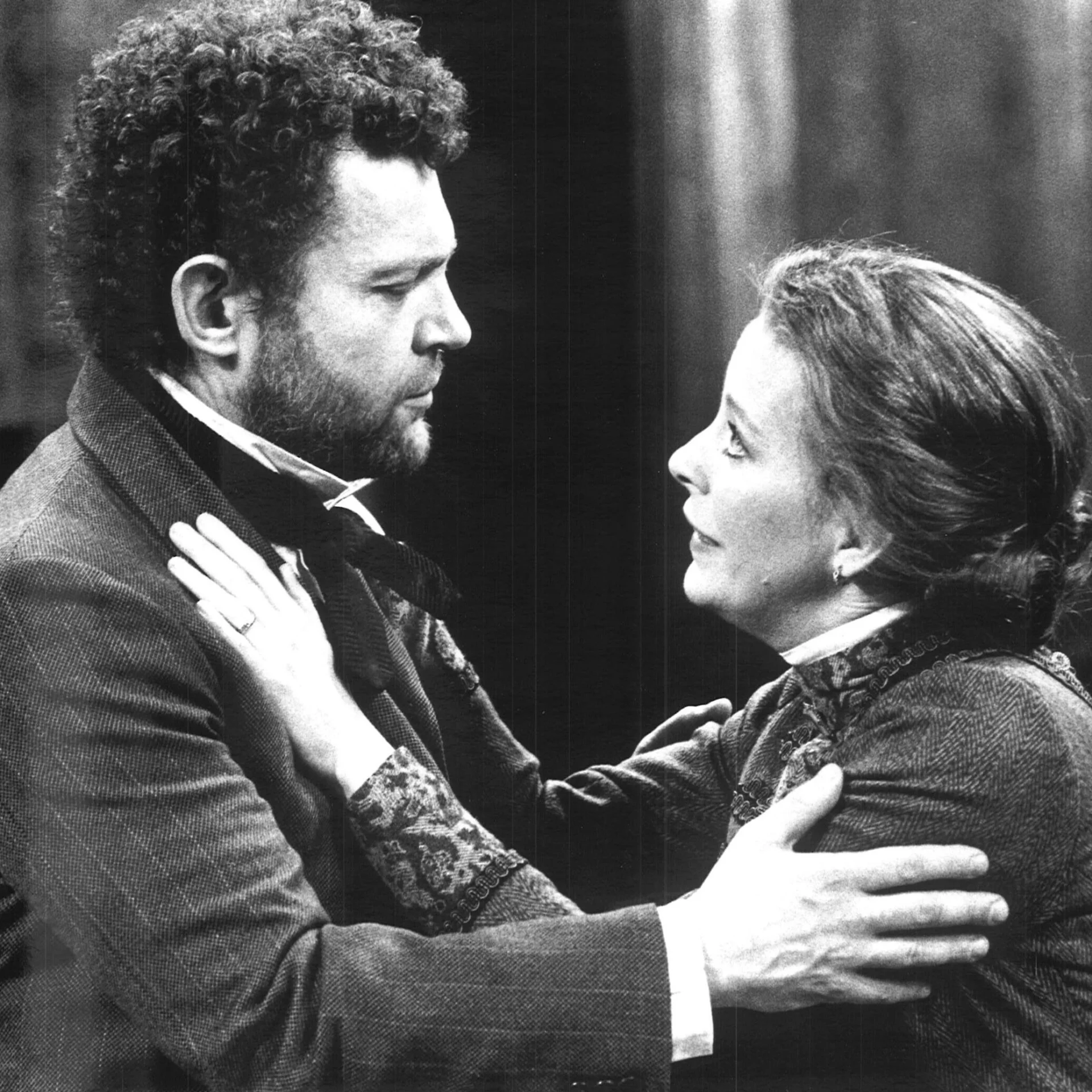 A Man and a woman are holding each other looking worried.