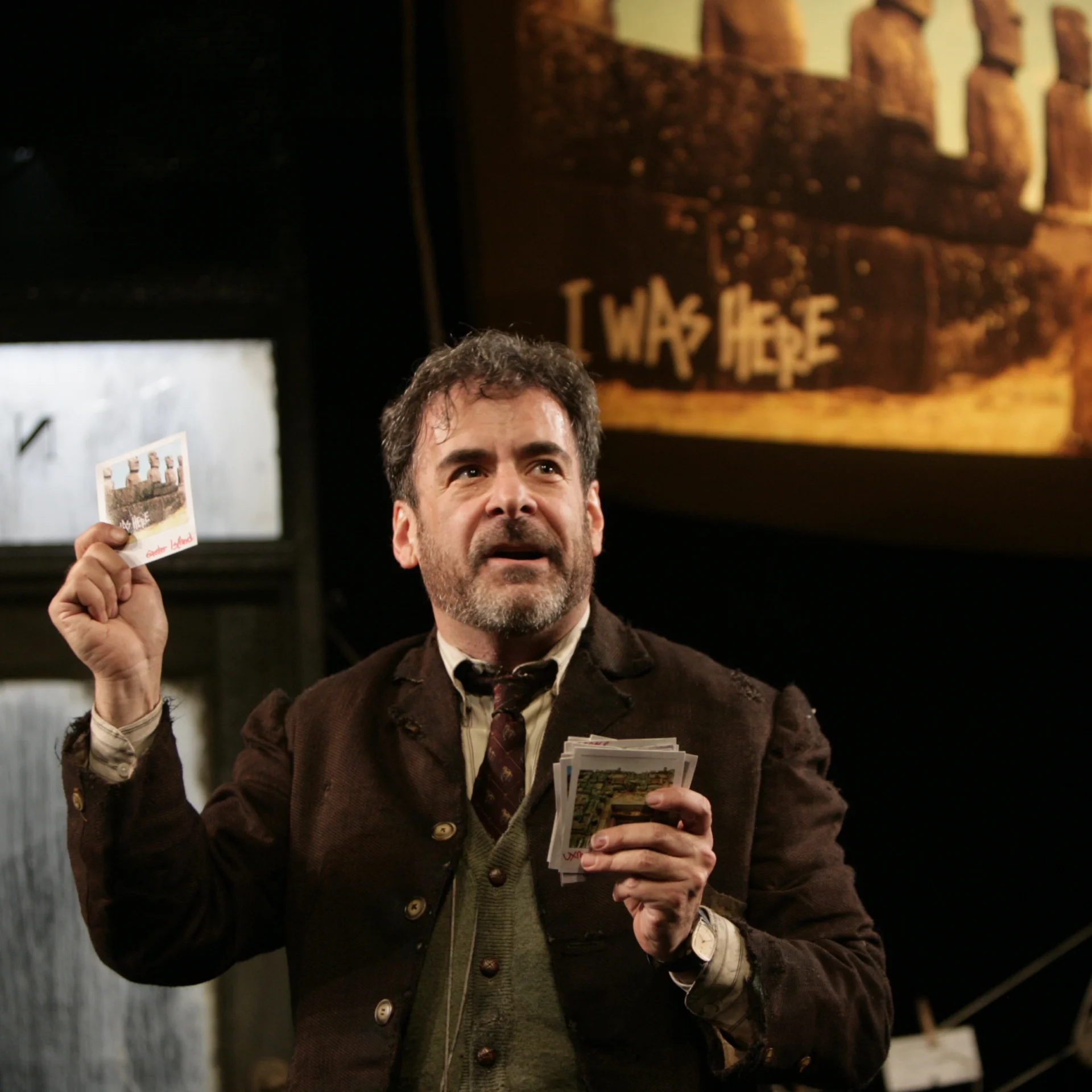 A man holding postcards speaks