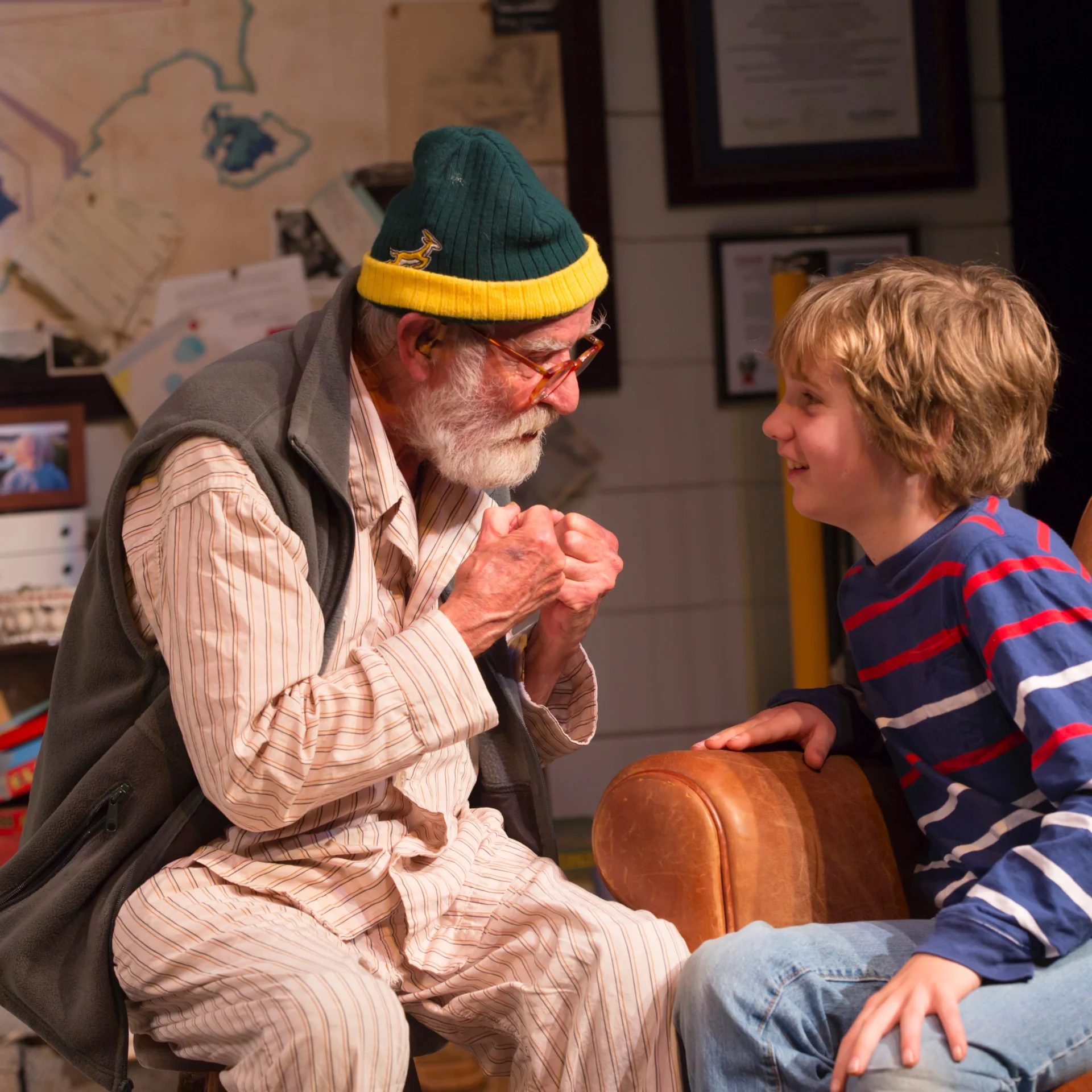 A young boy and older man sit in conversation